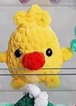 Yellow mini crochet chick with orange bill and tuft