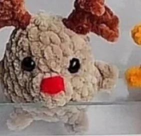 Beige miniature crochet reindeer with brown antlers and red nose