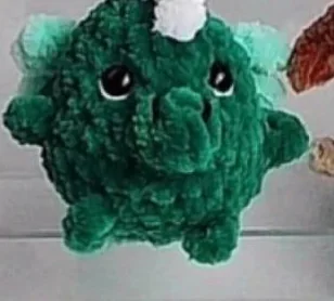Dark green crochet dinosaur or dragon with raised crest