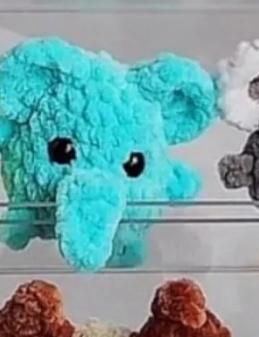 Bright turquoise mini crochet elephant with trunk and large ears
