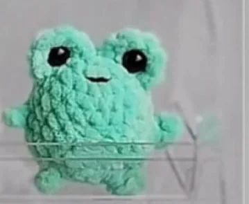 Mint green crocheted mini frog with two raised eyes