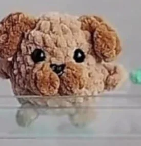 Brown and beige miniature crochet puppy with floppy ears