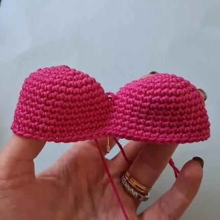 Two rounded pink crocheted heart tops joined into one heart-shaped plant body
